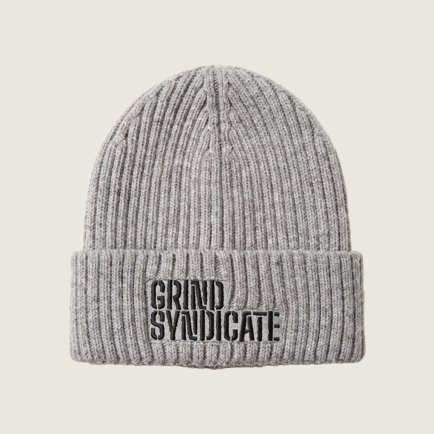 Grind Syndicate beanie in Ash Grey / Black Logo on a plain bone background