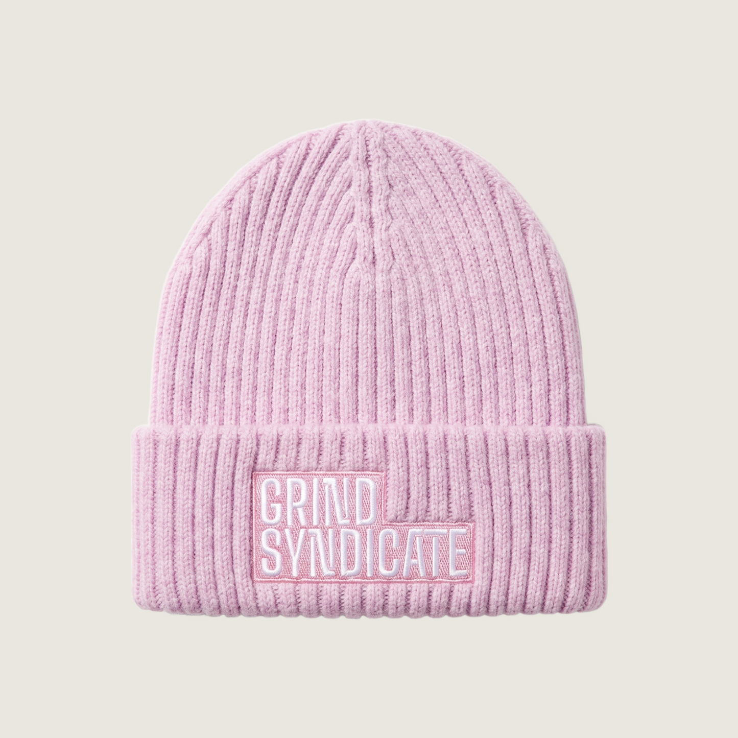 Grind Syndicate beanie in Pale Pink / White Logo on a plain bone background