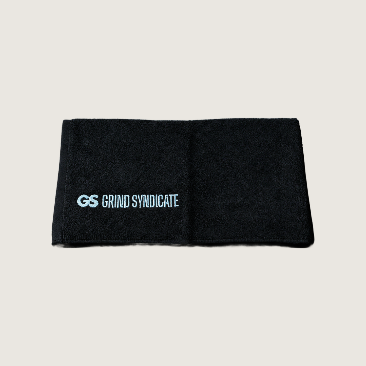 Grind Syndicate towel in Iced Blue on a plain bone background