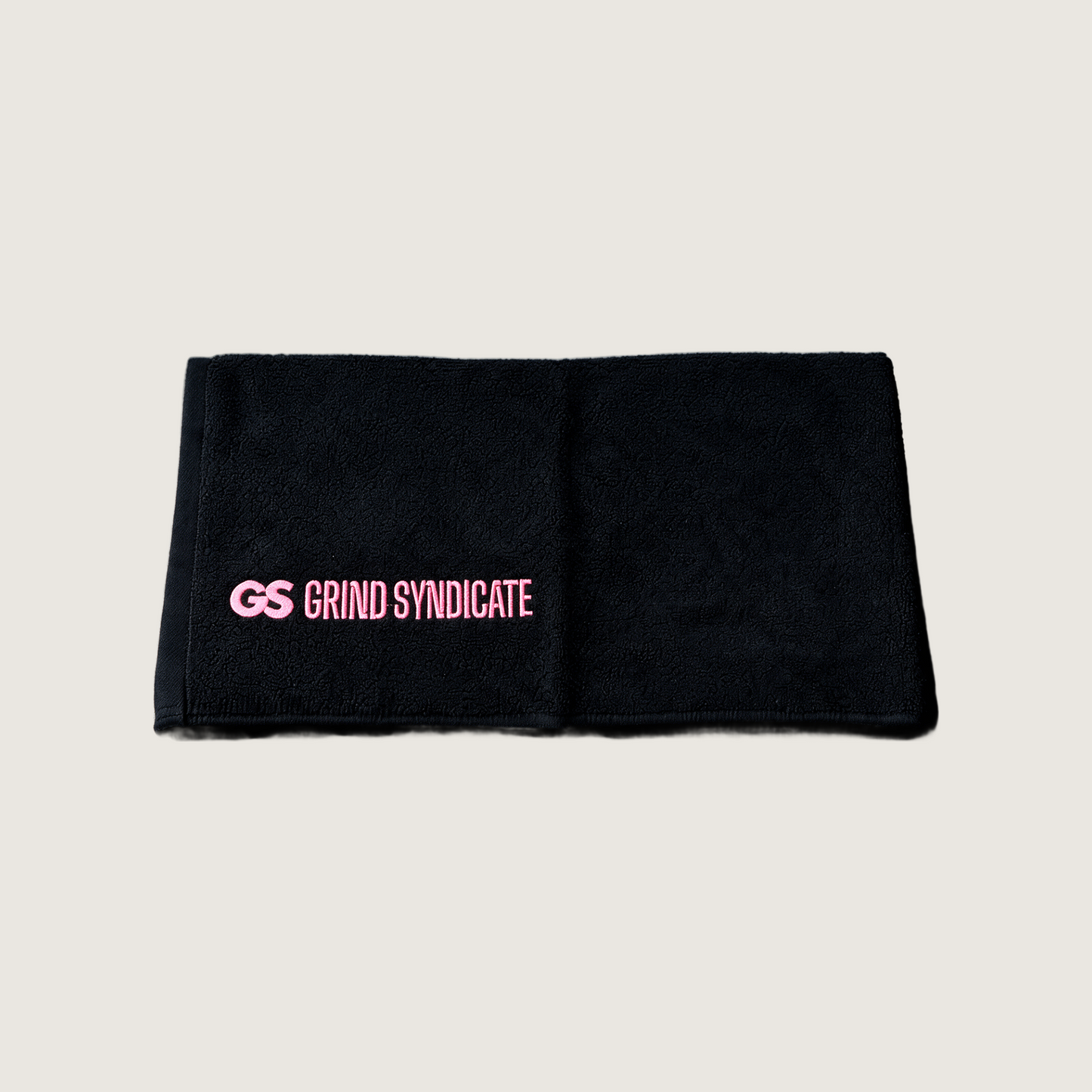 Grind Syndicate towel in Urban Pink on a plain bone background
