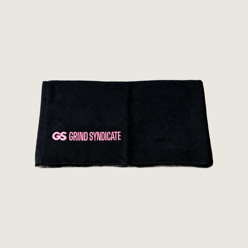 Grind Syndicate towel in Urban Pink on a plain bone background