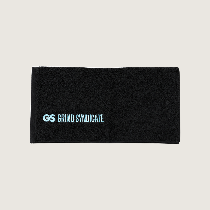Grind Syndicate cotton towel unfolded, iced blue logo, on a plain bone background