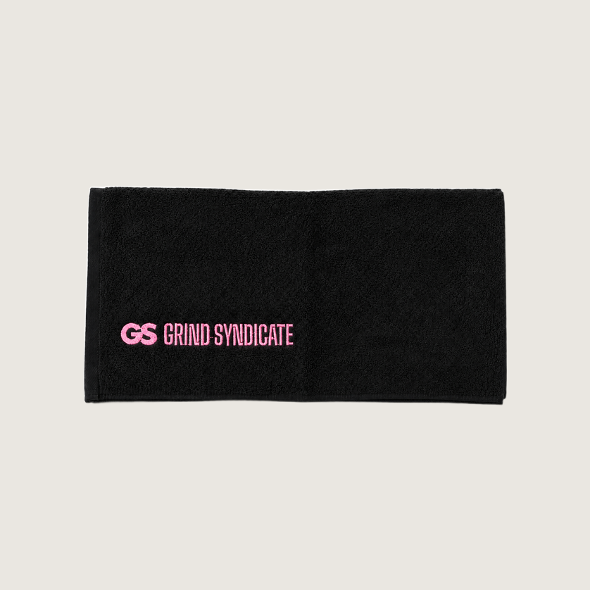Grind Syndicate cotton towel unfolded, urban pink logo, on a plain bone background
